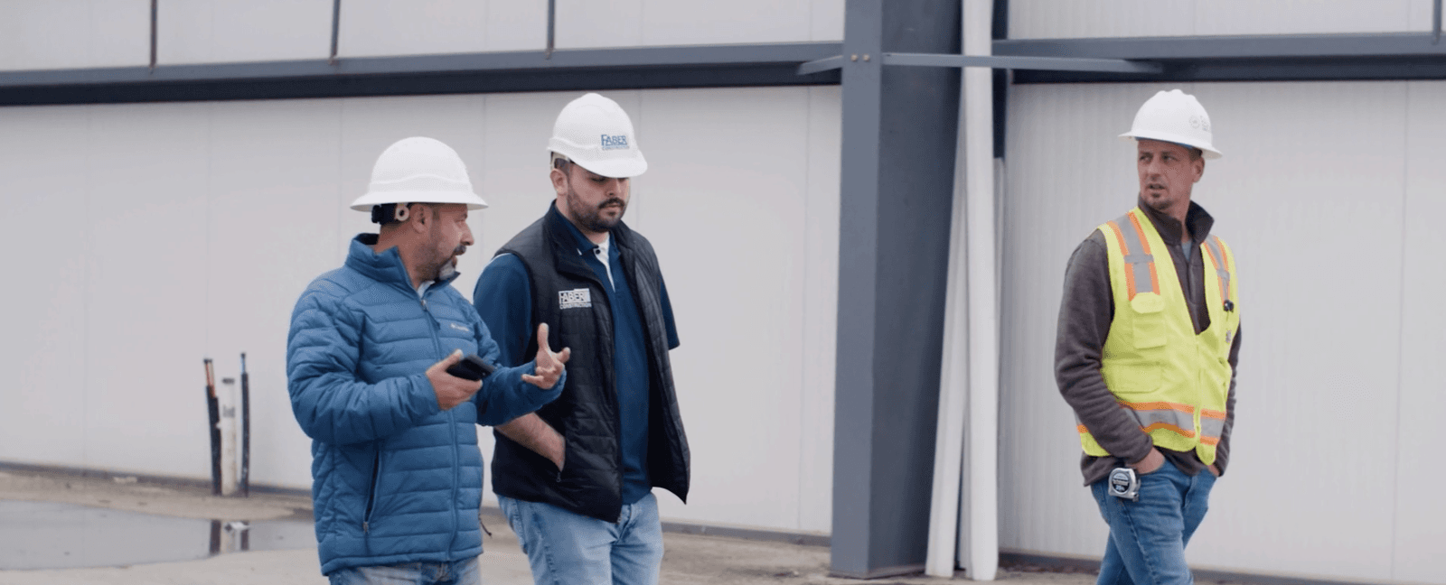 Faber team members walking on a construction site
